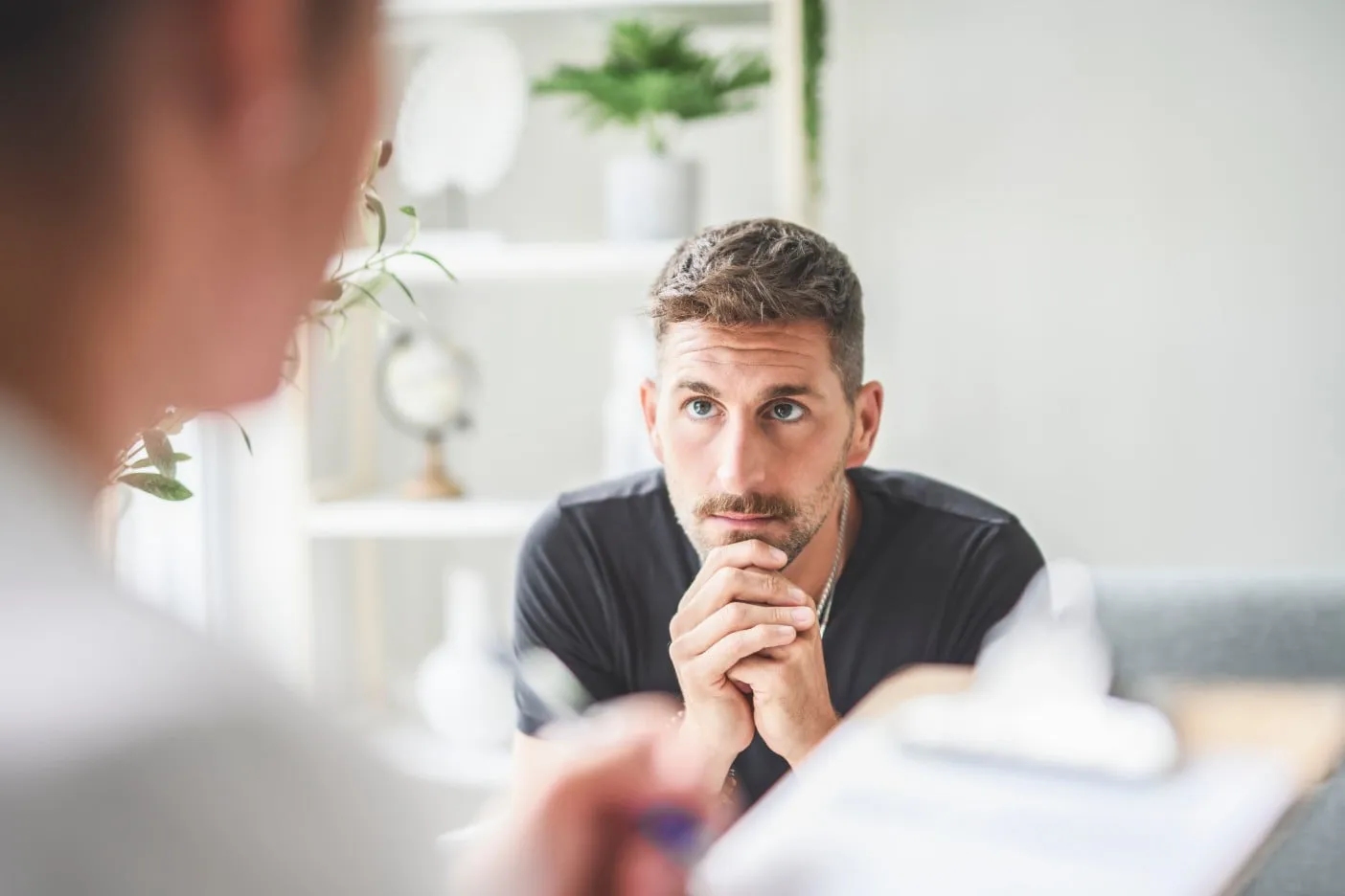 a man listening to someone talking